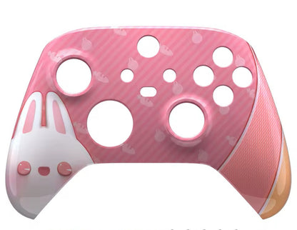 Pink and white gaming controller shell with tools and screws on a white background